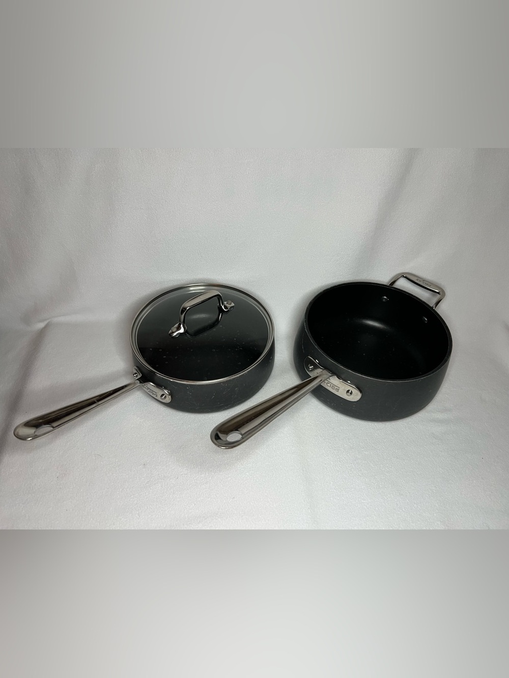 All-Clad hard-anodized nonstick saucepans, with the 2.5-qt and 3.5-qt set 1 lid